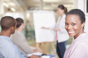 woman in meeting smiling